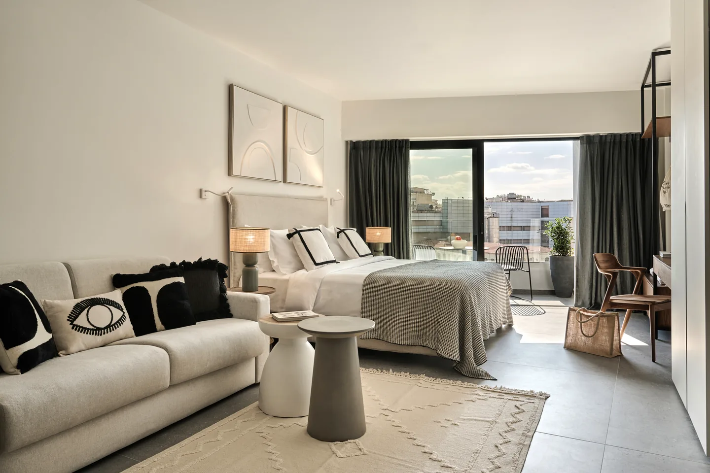The Deluxe Room at FŌS — soft natural light, balcony beyond.