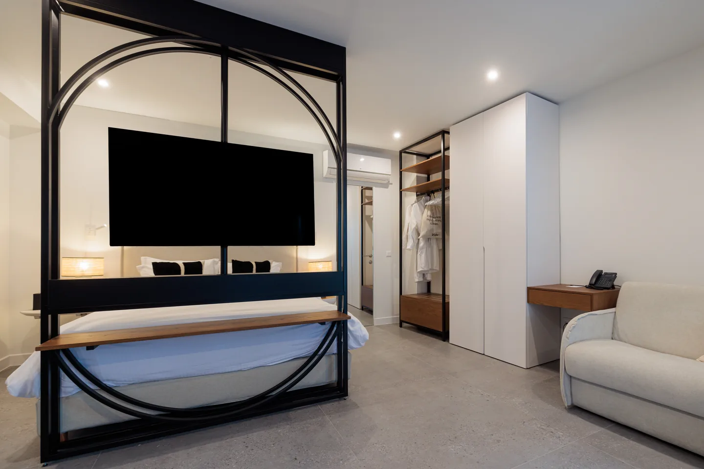 The Suite at FŌS — sitting area beside a tall window.